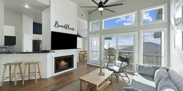 Image 3: The living room is bright and airy, featuring vaul