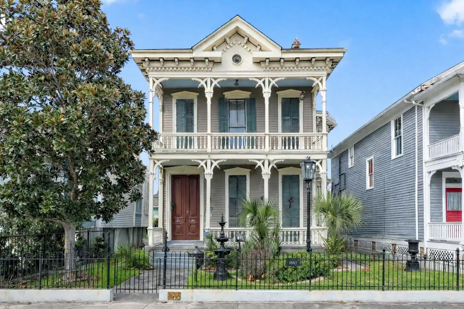 Image 1: Victorian-style two-story home with ornate detaili