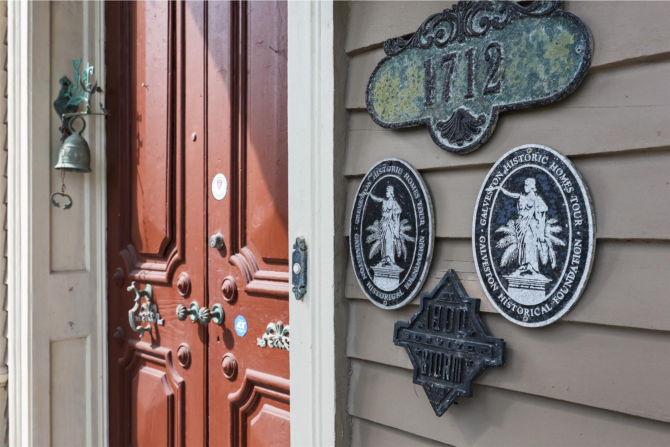 Image 2: Historic home with a charming red wooden door, ado