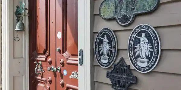Image 2: Historic home with a charming red wooden door, ado