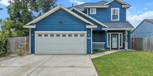 Image 2: Welcoming two-story home with covered front porch