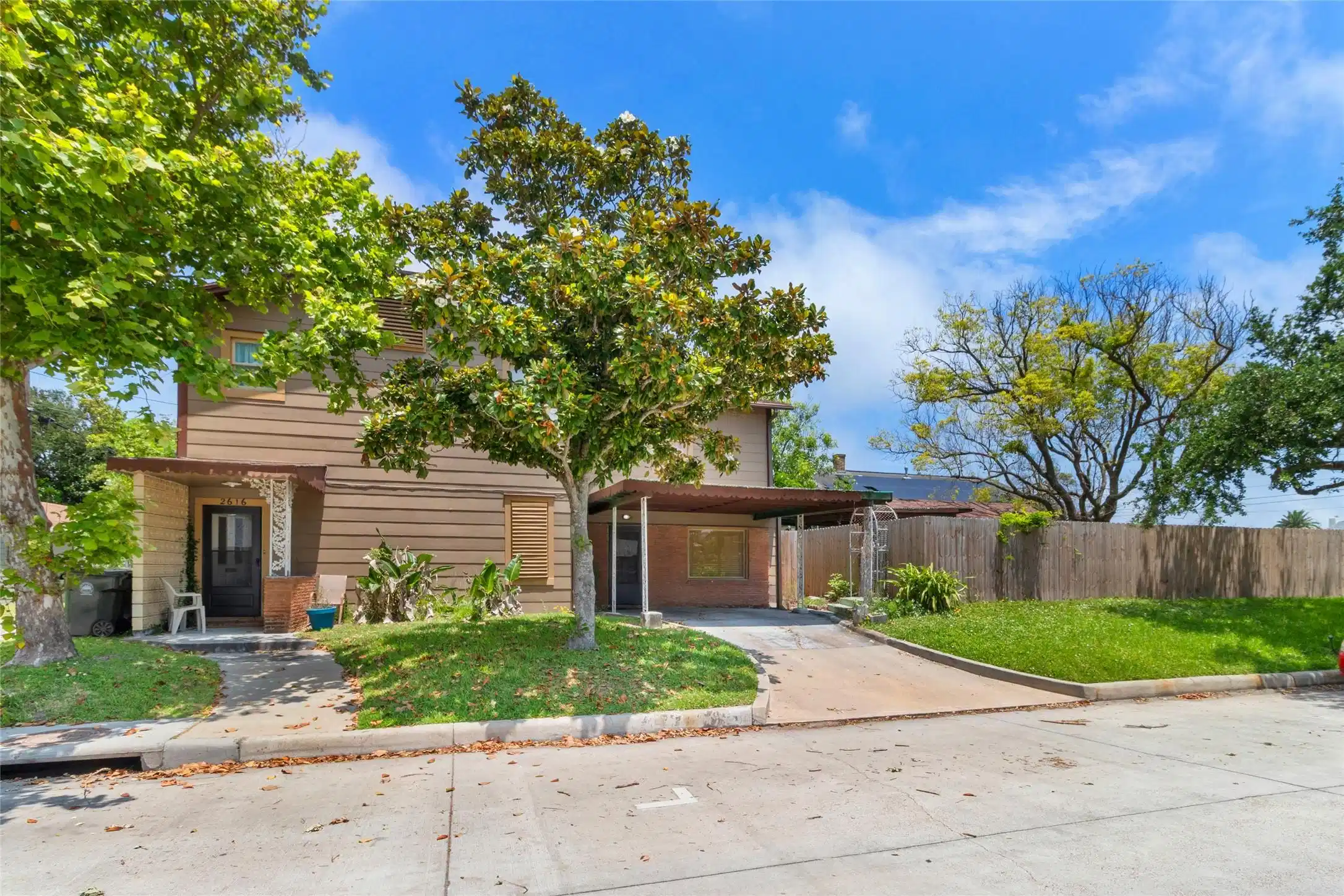 Image 1: This photo features a two-story house with a woode