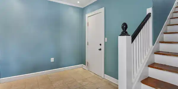 Image 2: This photo shows a welcoming entryway with blue wa