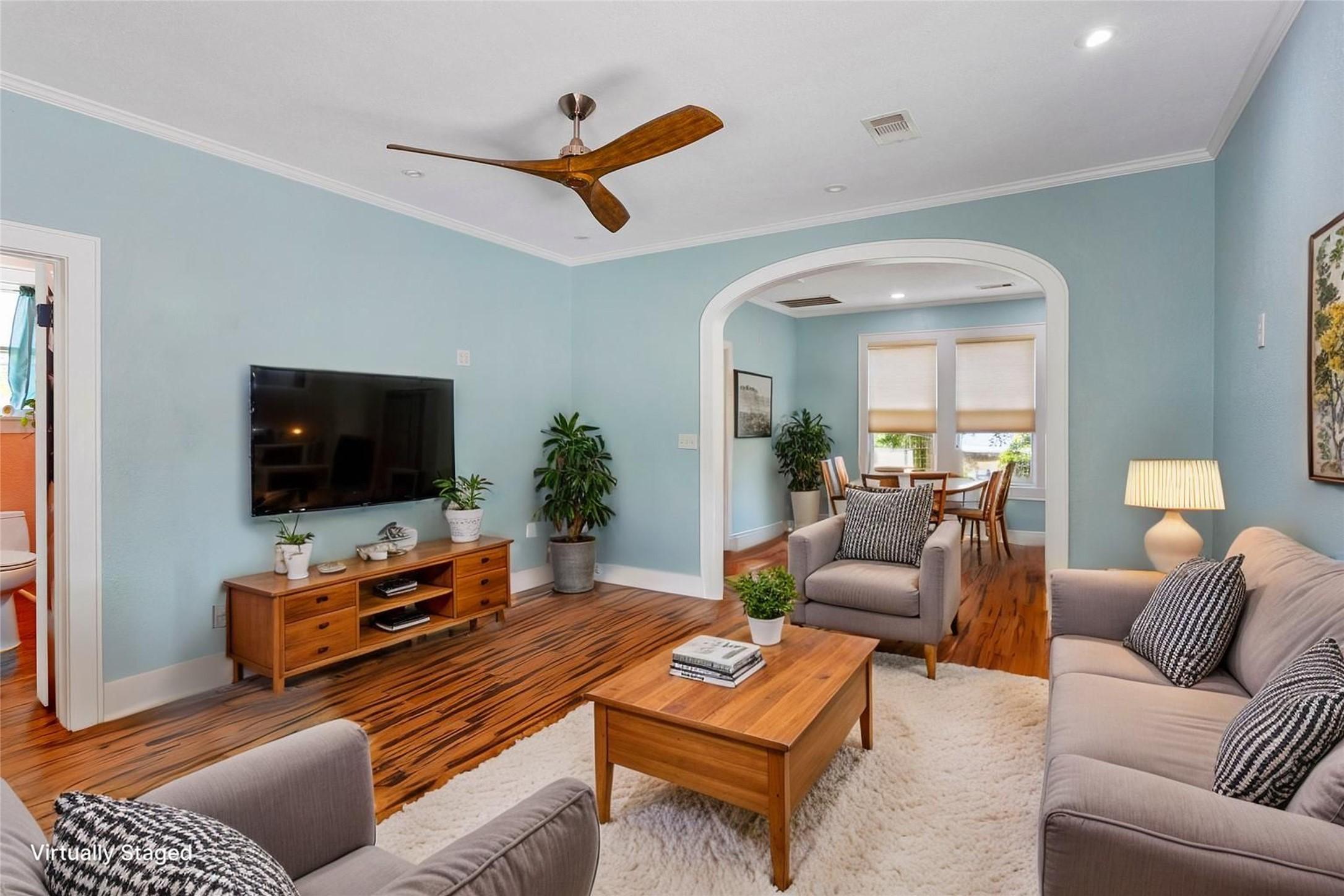 Image 4: This photo showcases a cozy living room with light
