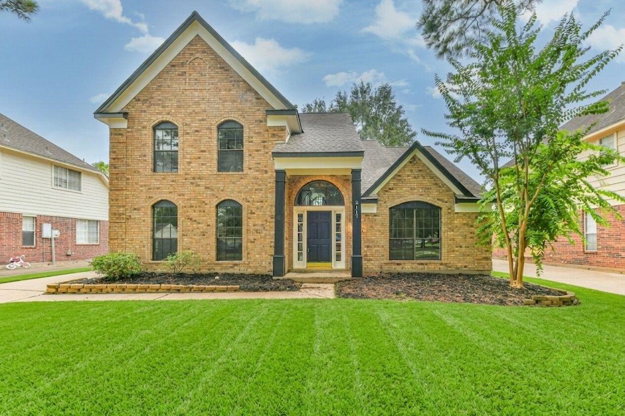 Image 1: Charming two-story brick home features a classic d