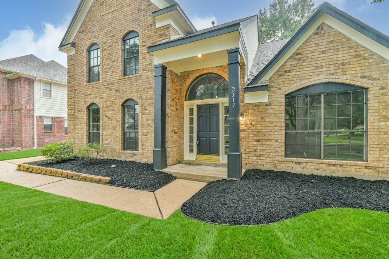 Image 3: Brick home with a welcoming front entrance featuri