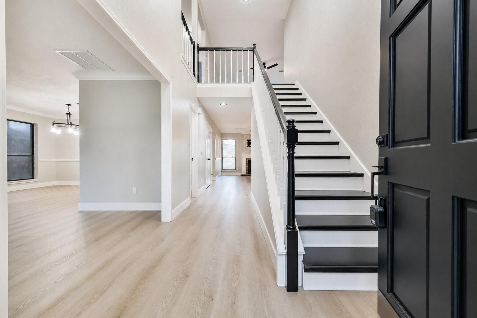 Image 4: Inviting entryway features a modern black-and-whit