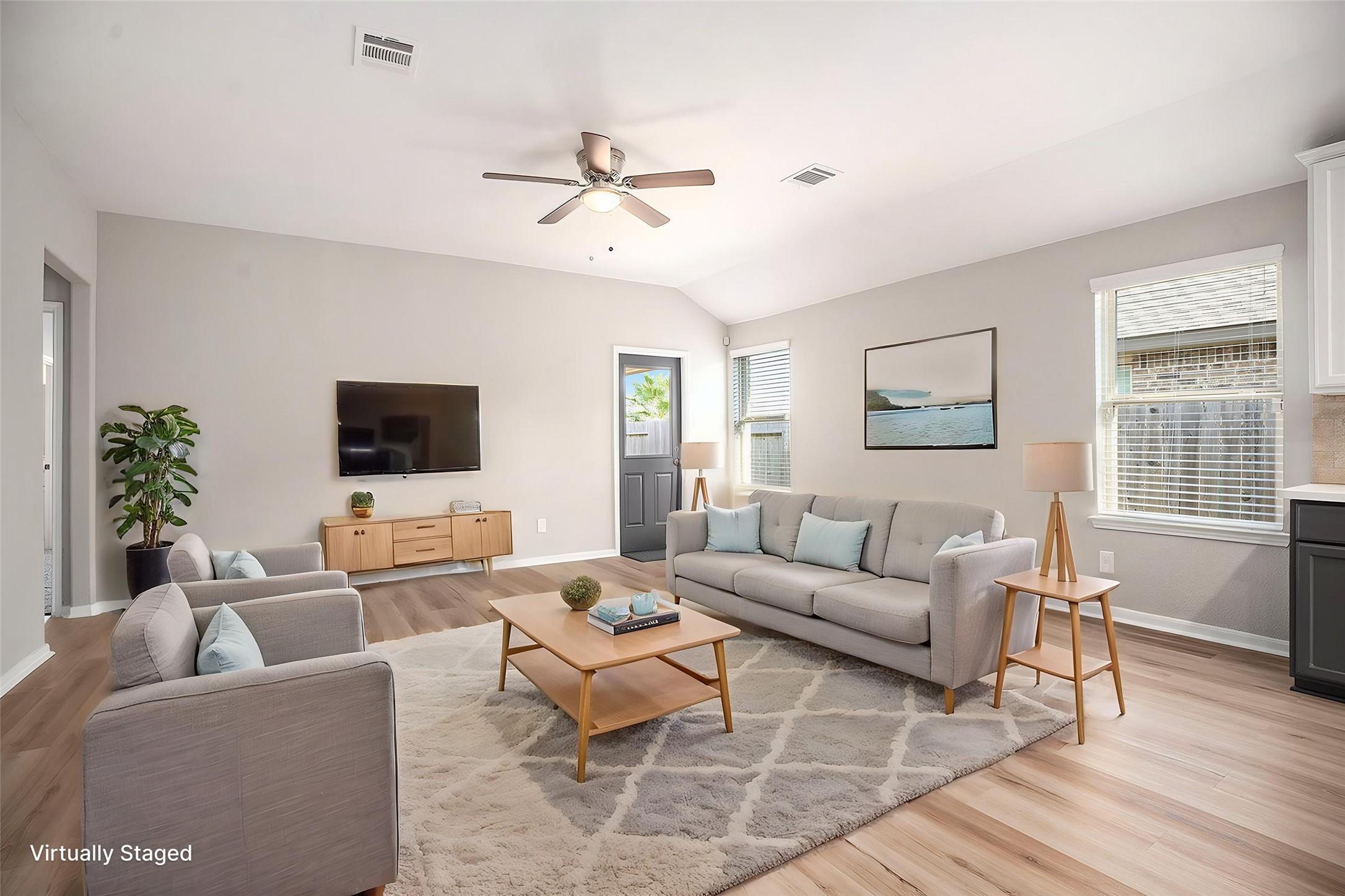 Image 2: Virtually staged living room showcasing the open-c