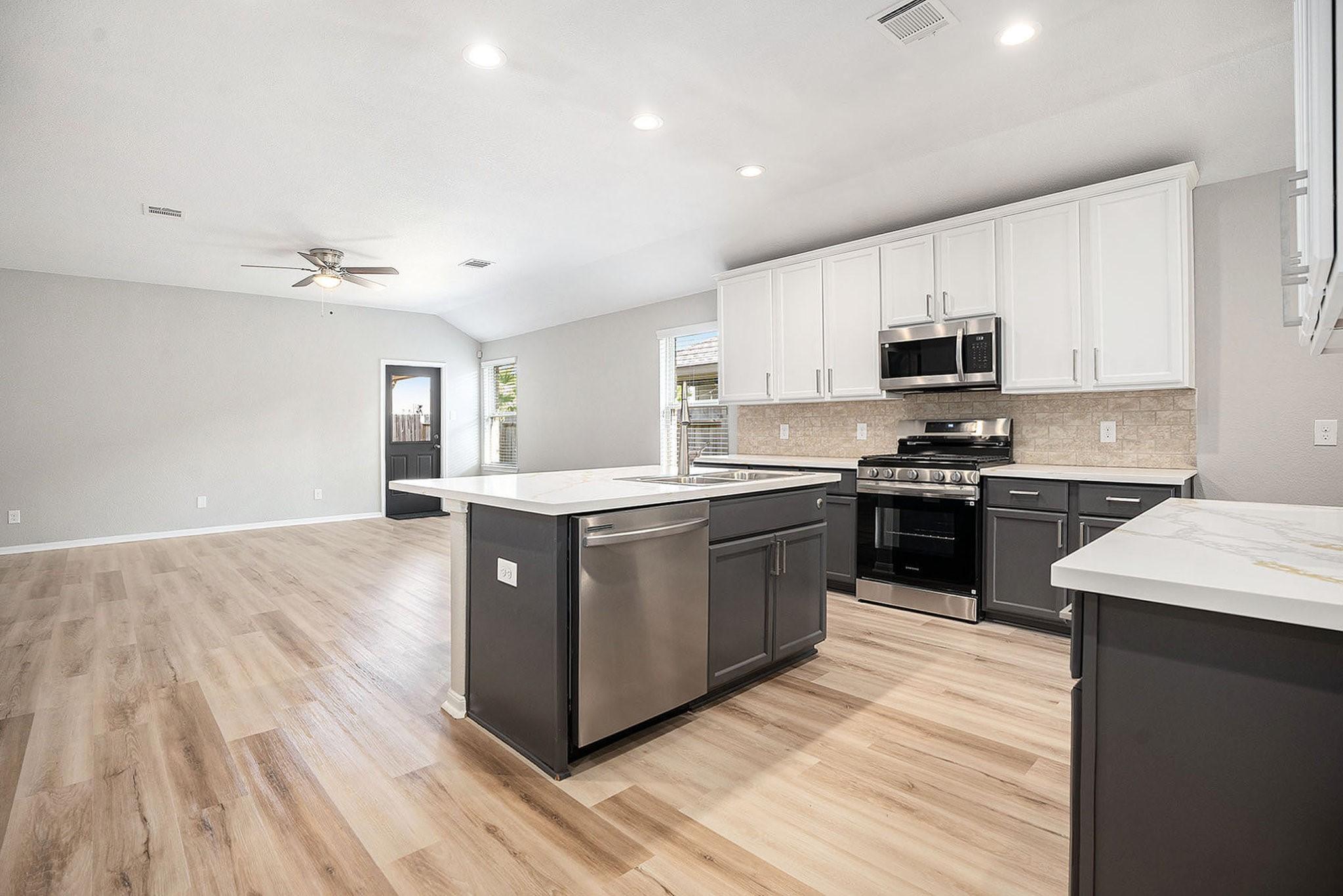 Image 3: This photo showcases a spacious, open-concept kitc