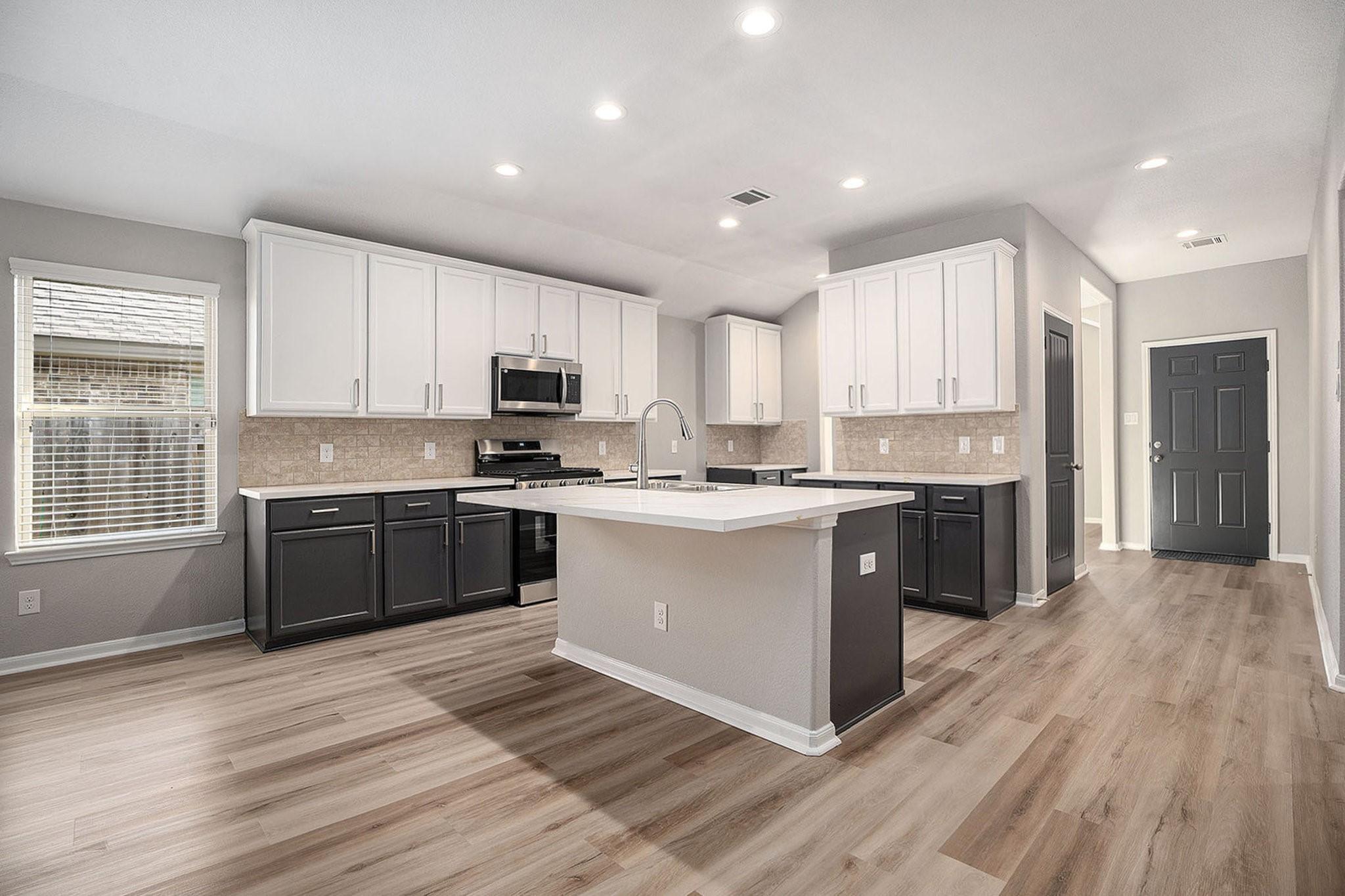 Image 4: This modern kitchen features a spacious open layou