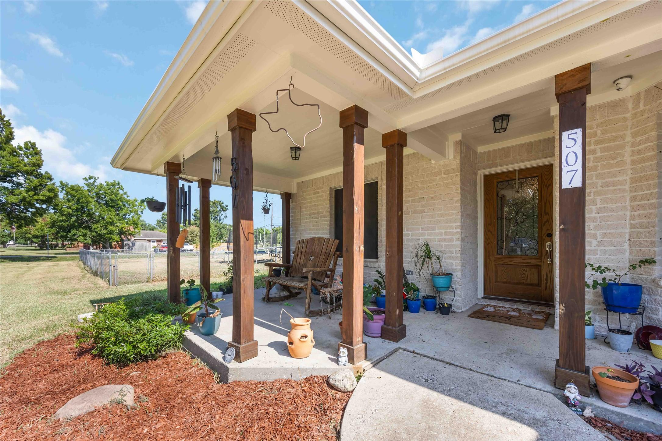 Image 2: This front porch gets added shade from the beautif
