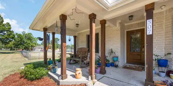 Image 2: This front porch gets added shade from the beautif