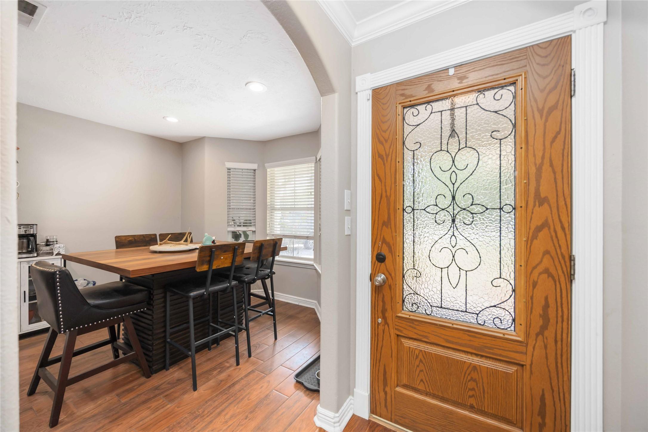 Image 4: Spacious dining area next to large windows.