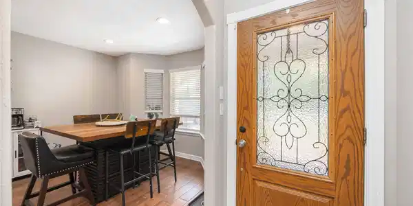 Image 4: Spacious dining area next to large windows.