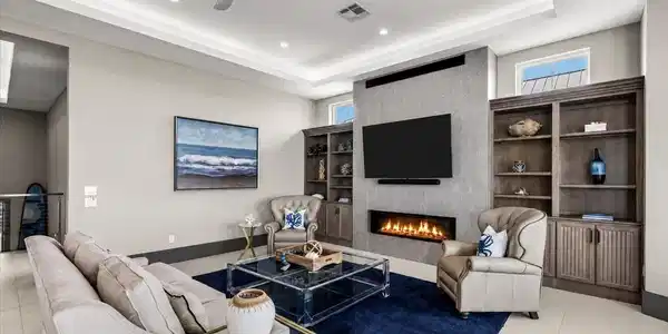 Image 4: This spacious living room features a sleek gas fir