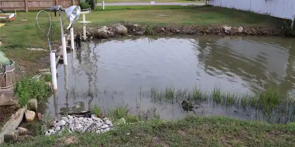 Image 4: This photo shows a backyard with a small waterway,