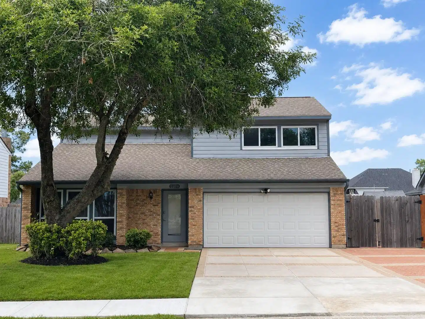 Image 1: Front elevation with brick-and-siding exterior, tw