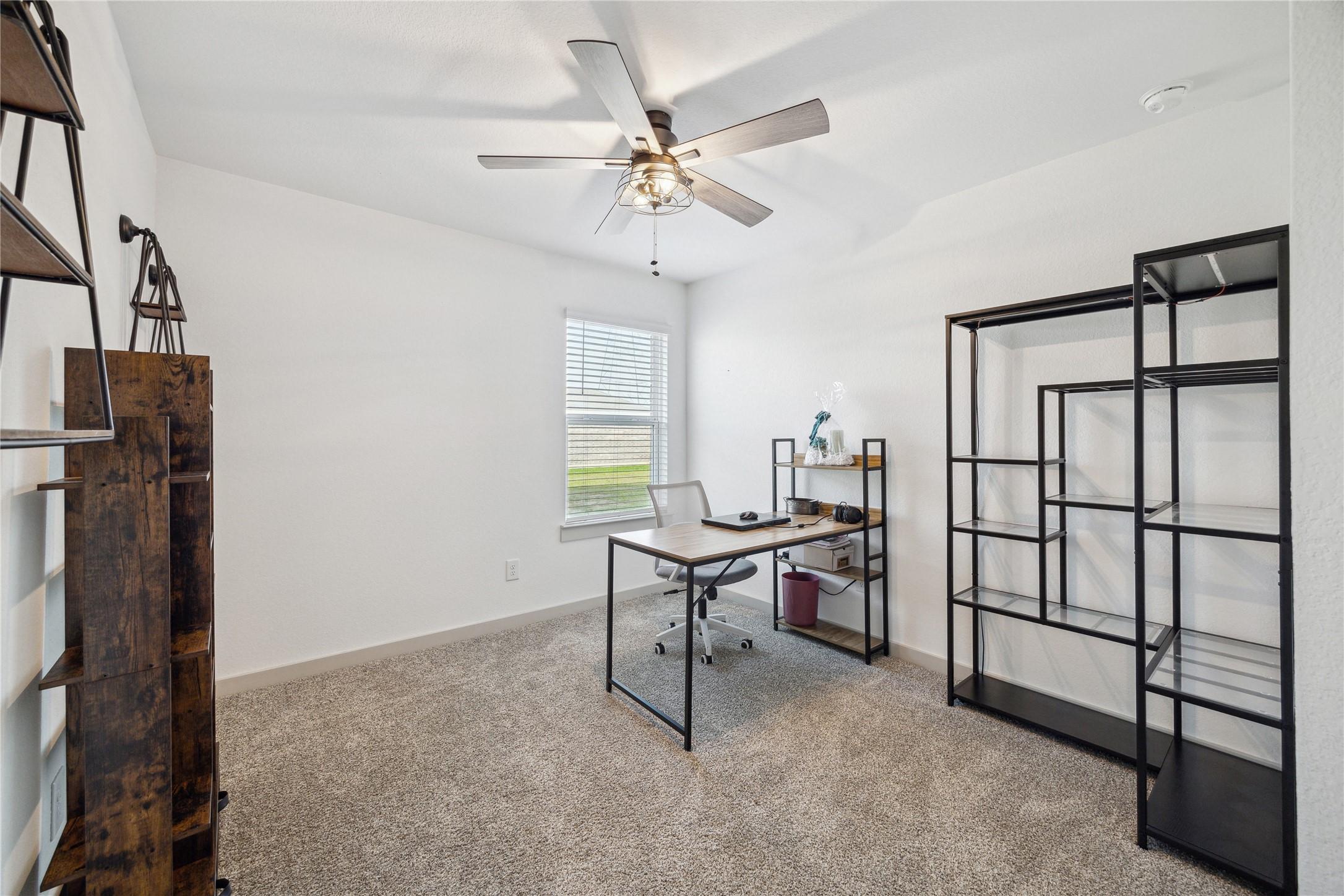 Image 4: Showcasing a bright, carpeted home office with a c