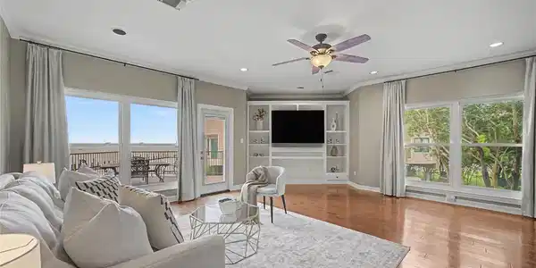 Image 2: view of the open concept living room with a slidin