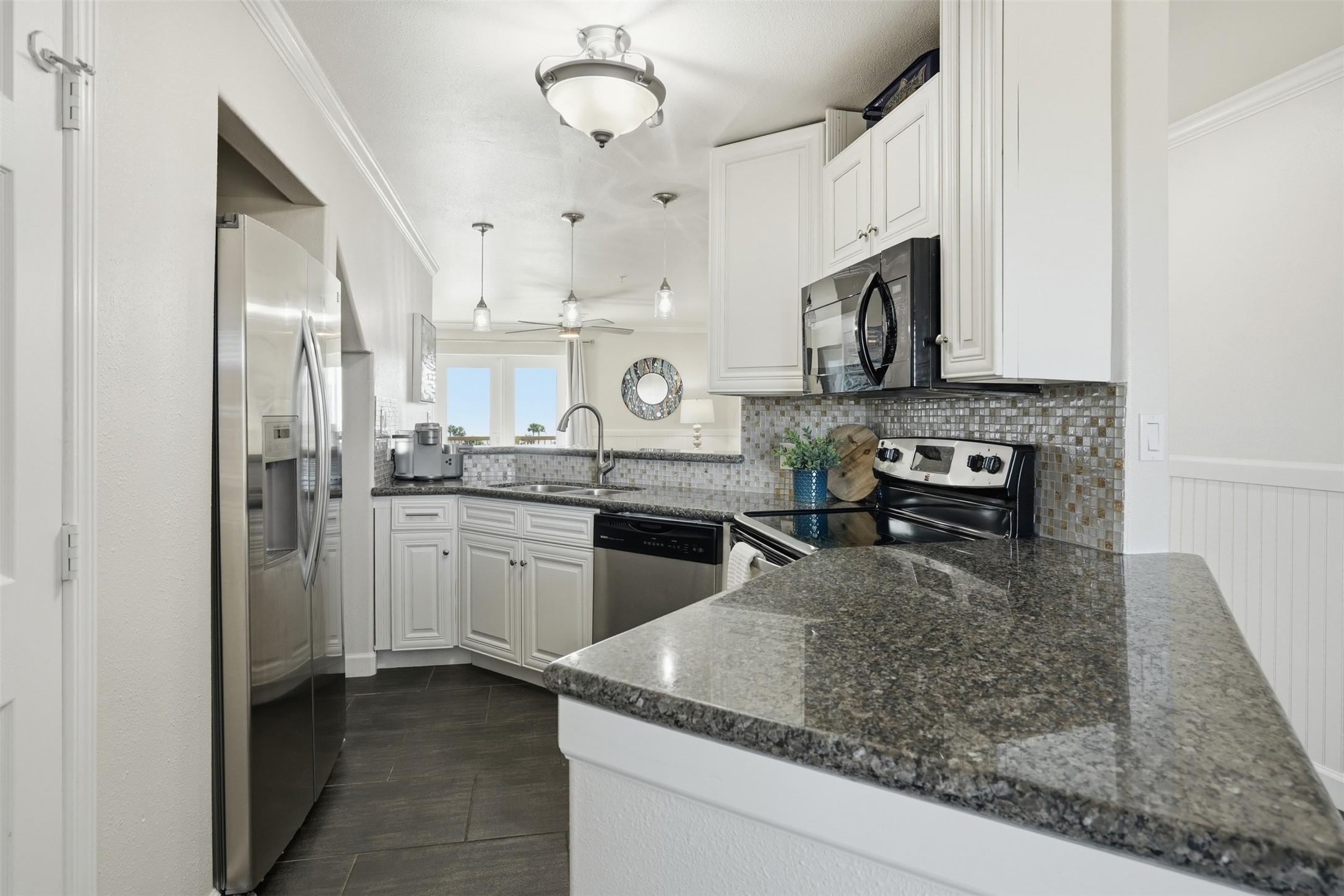 Image 4: This modern kitchen features stainless steel appli