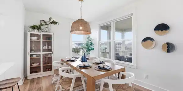 Image 3: Bright dining area with coastal inspired finishes,