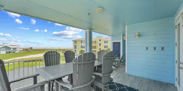 Image 3: This spacious covered balcony offers peaceful view