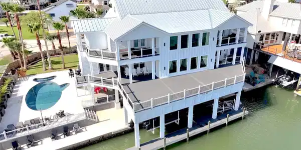 Image 3: The pool, expansive decks and canal come together