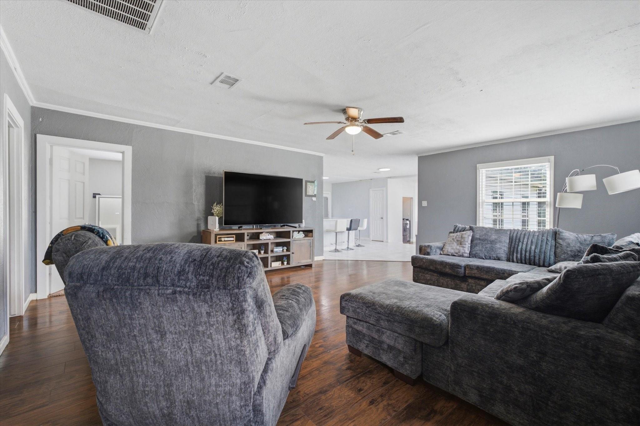 Image 3: Spacious open-concept living room with beautiful w