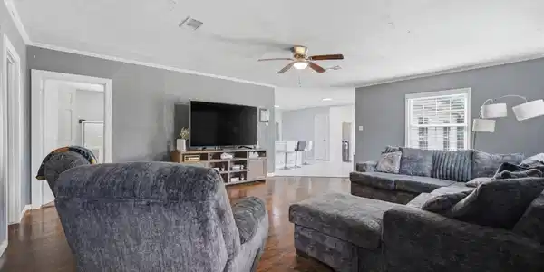 Image 3: Spacious open-concept living room with beautiful w