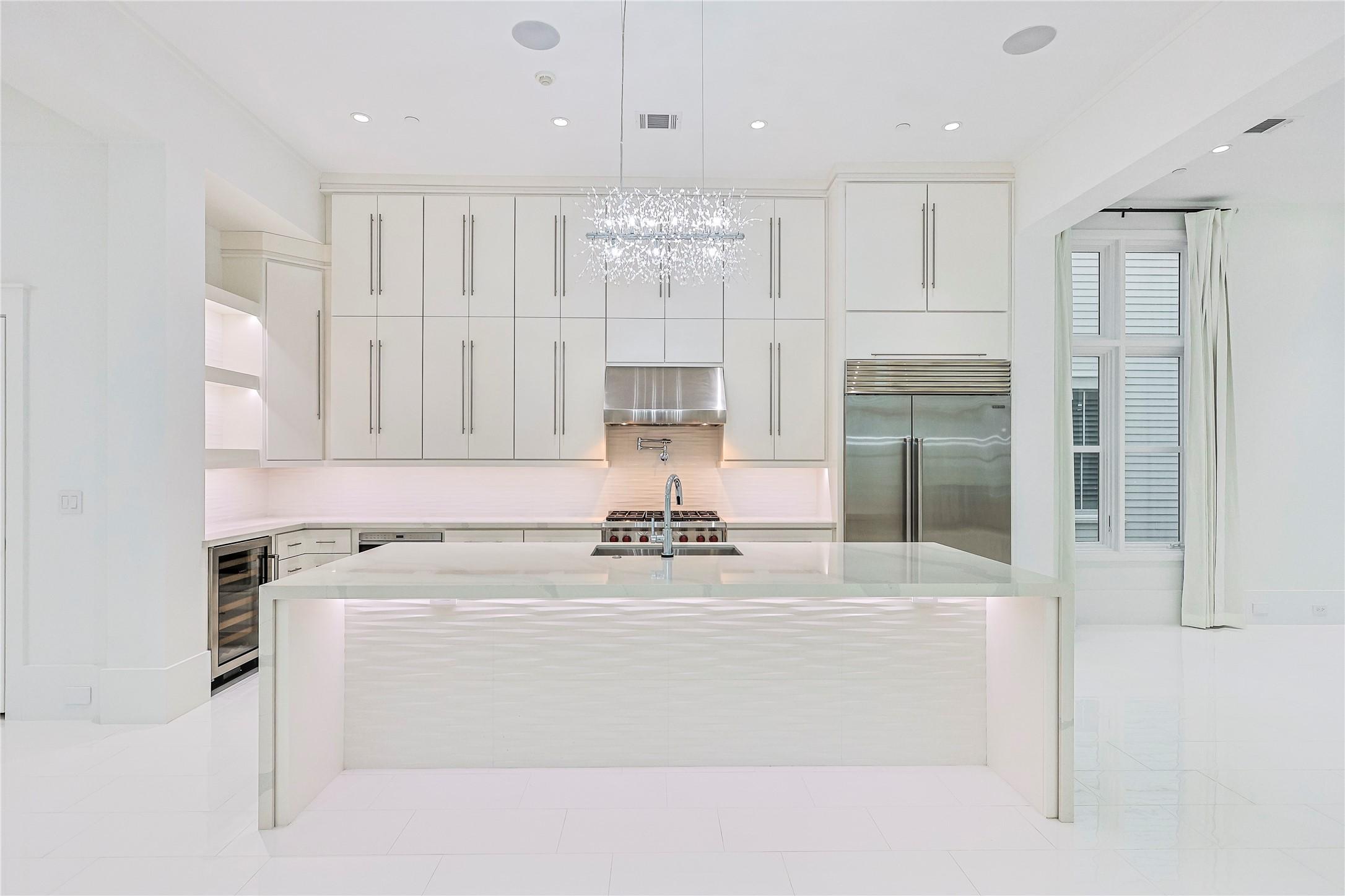 Image 4: This sleek, ultra-modern kitchen is a true showsto