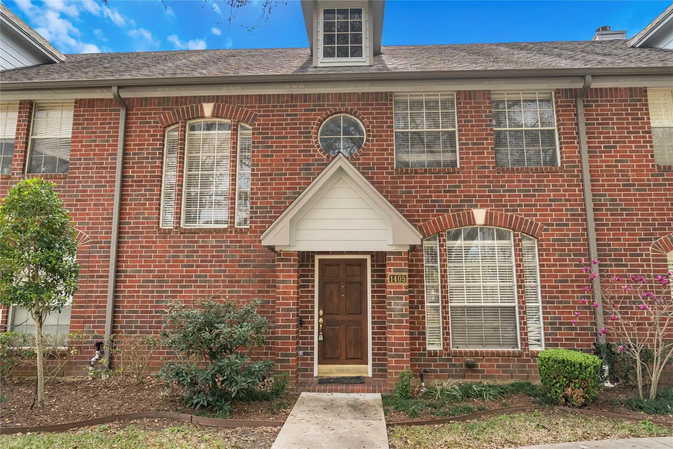 Image 1: Charming two-story brick townhouse with classic de