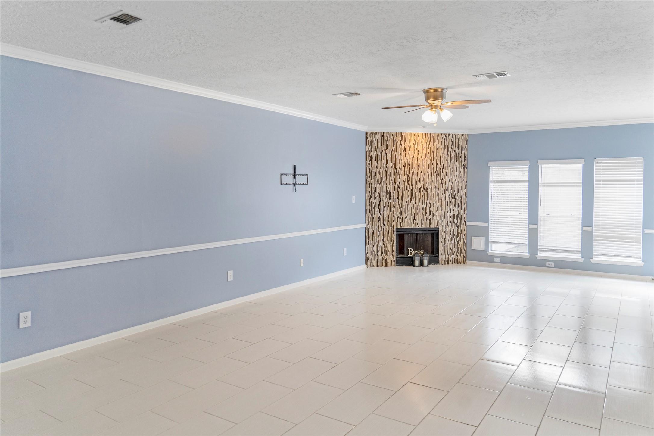 Image 3: Spacious living room with light blue walls, white