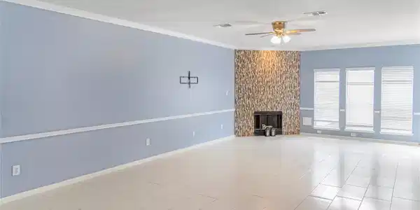 Image 3: Spacious living room with light blue walls, white