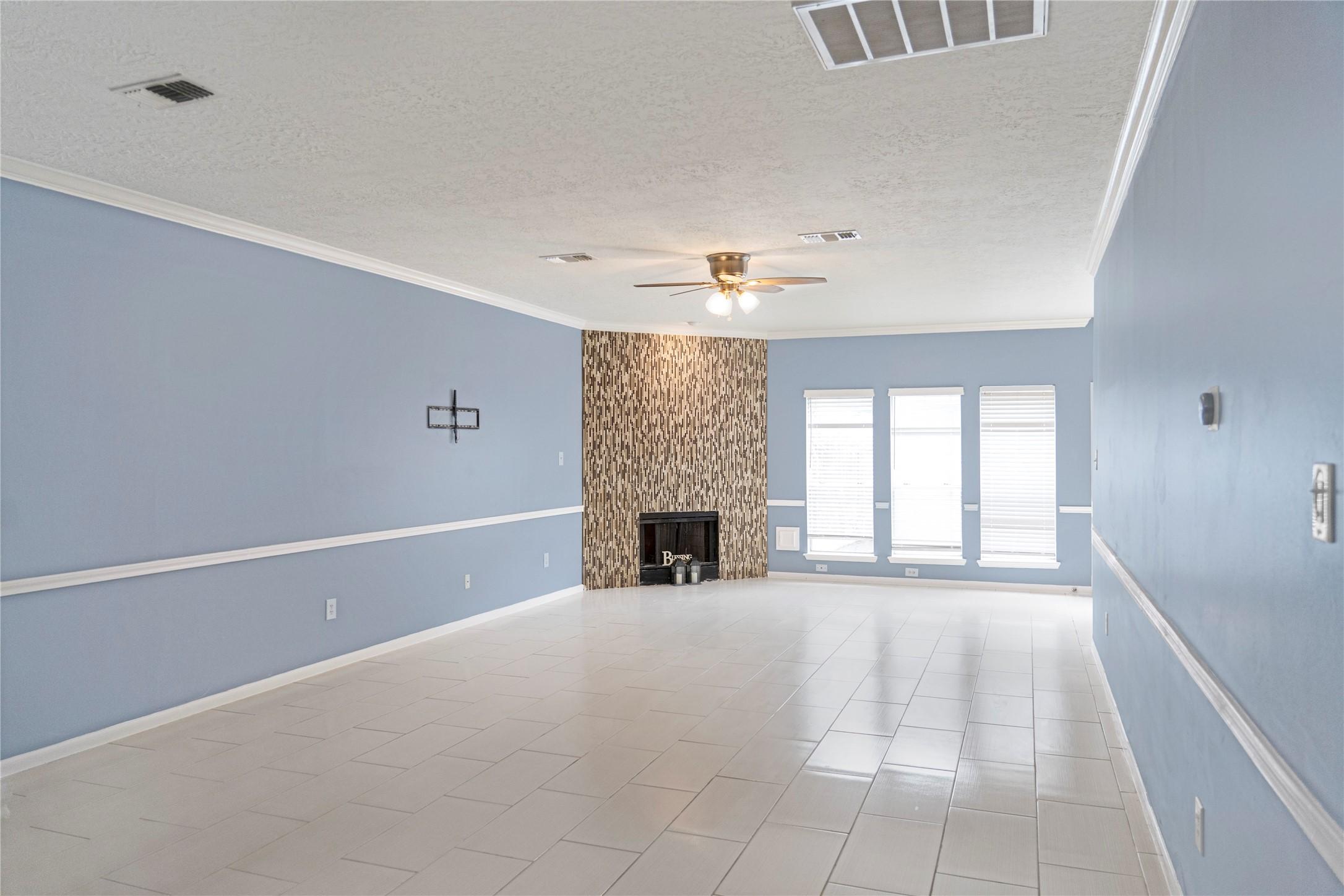 Image 4: This spacious living room features light blue wall