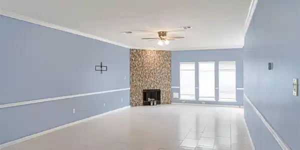Image 4: This spacious living room features light blue wall