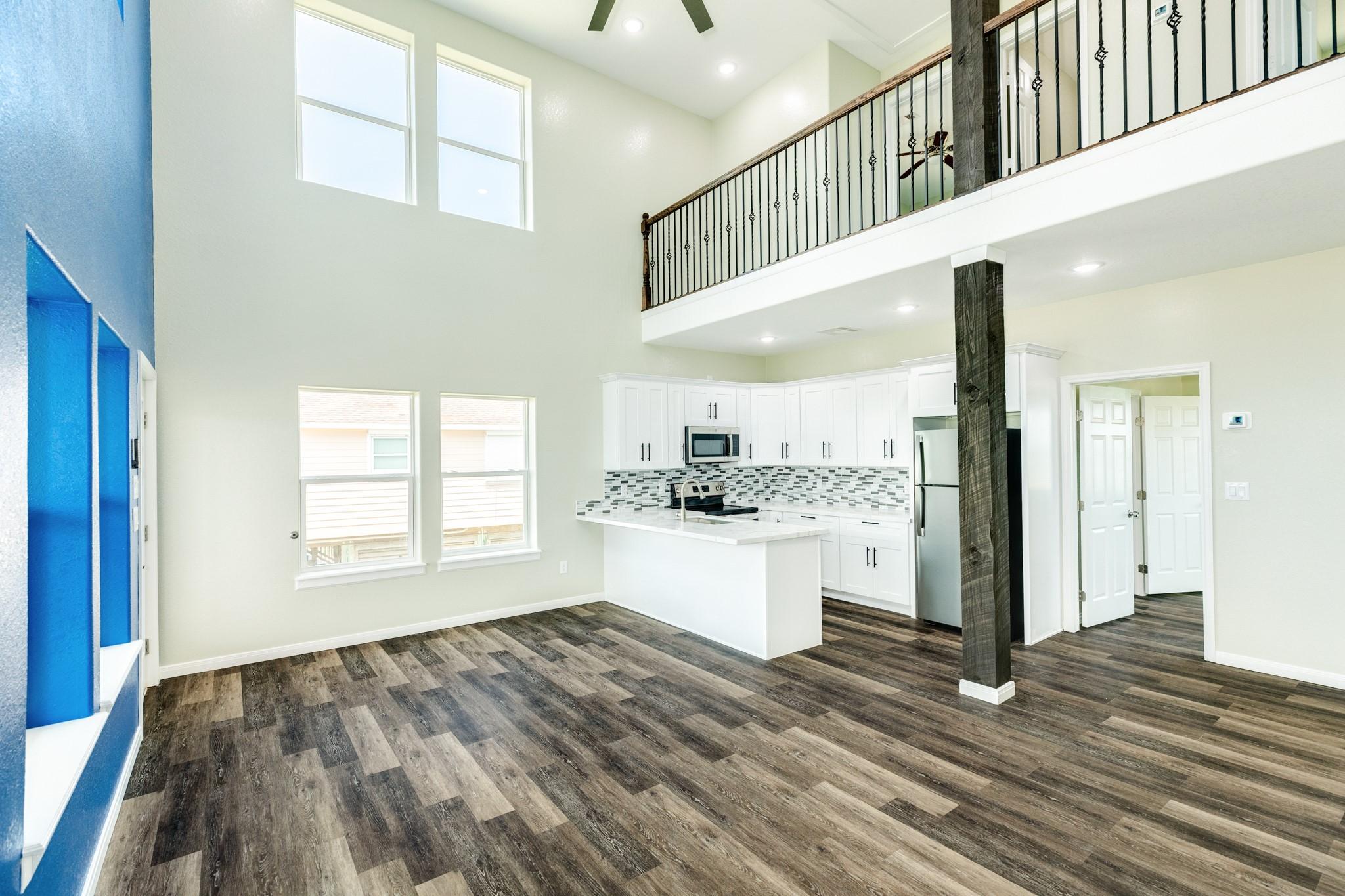 Image 3: Tall ceilings with recessed lighting add to the al