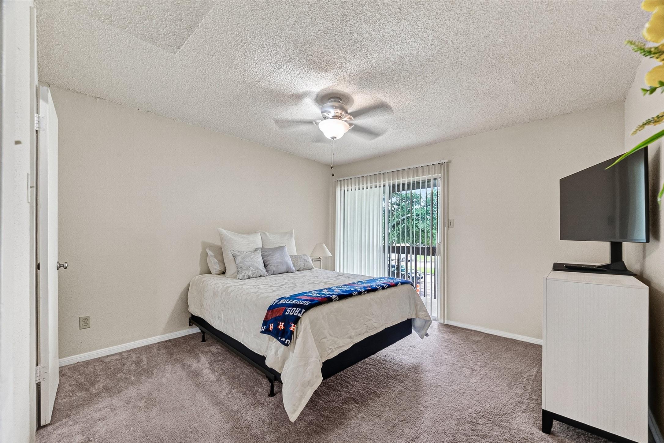 Image 4: The bedroom is large, there's direct access to the