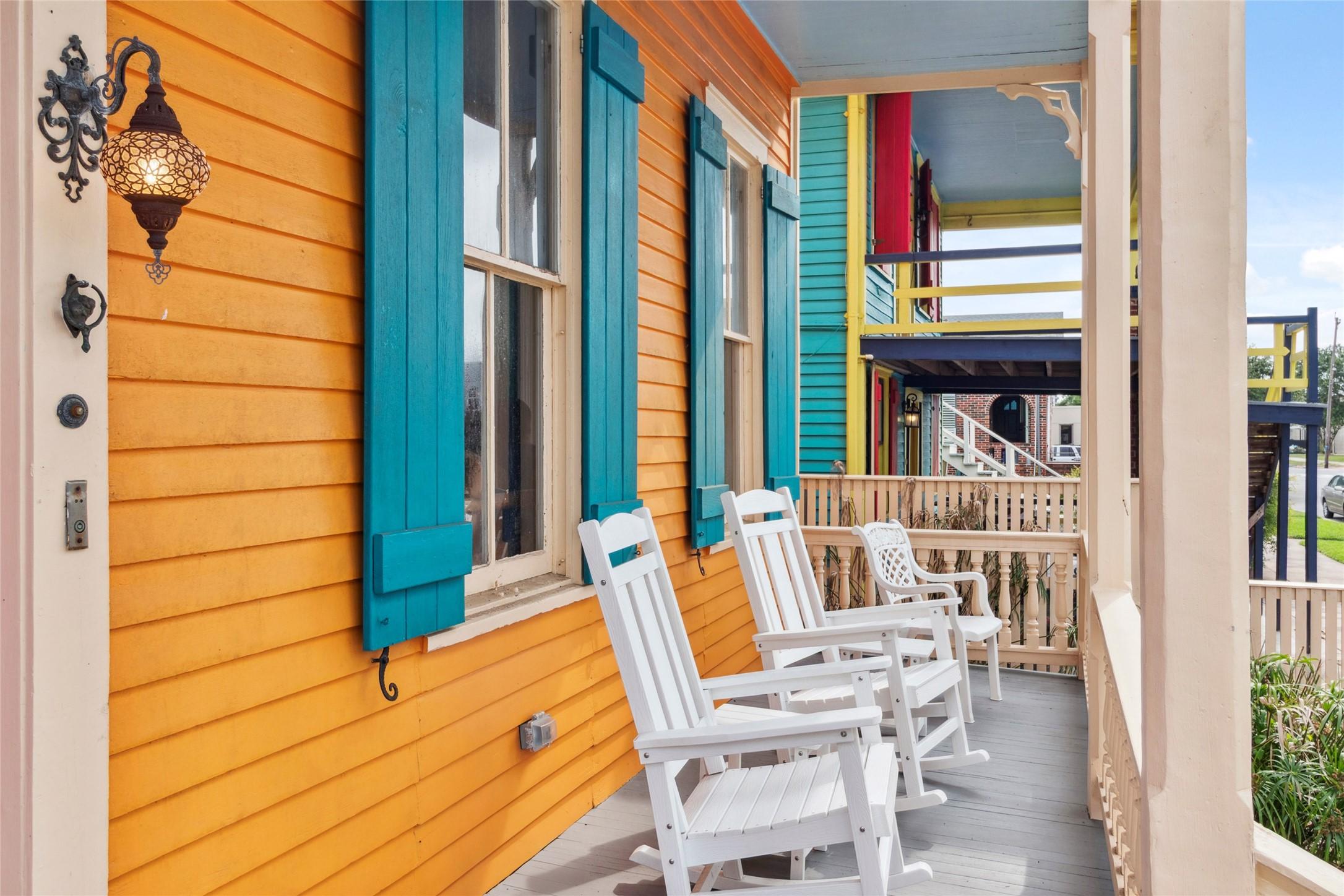 Image 3: This vibrant porch features a bold orange and turq