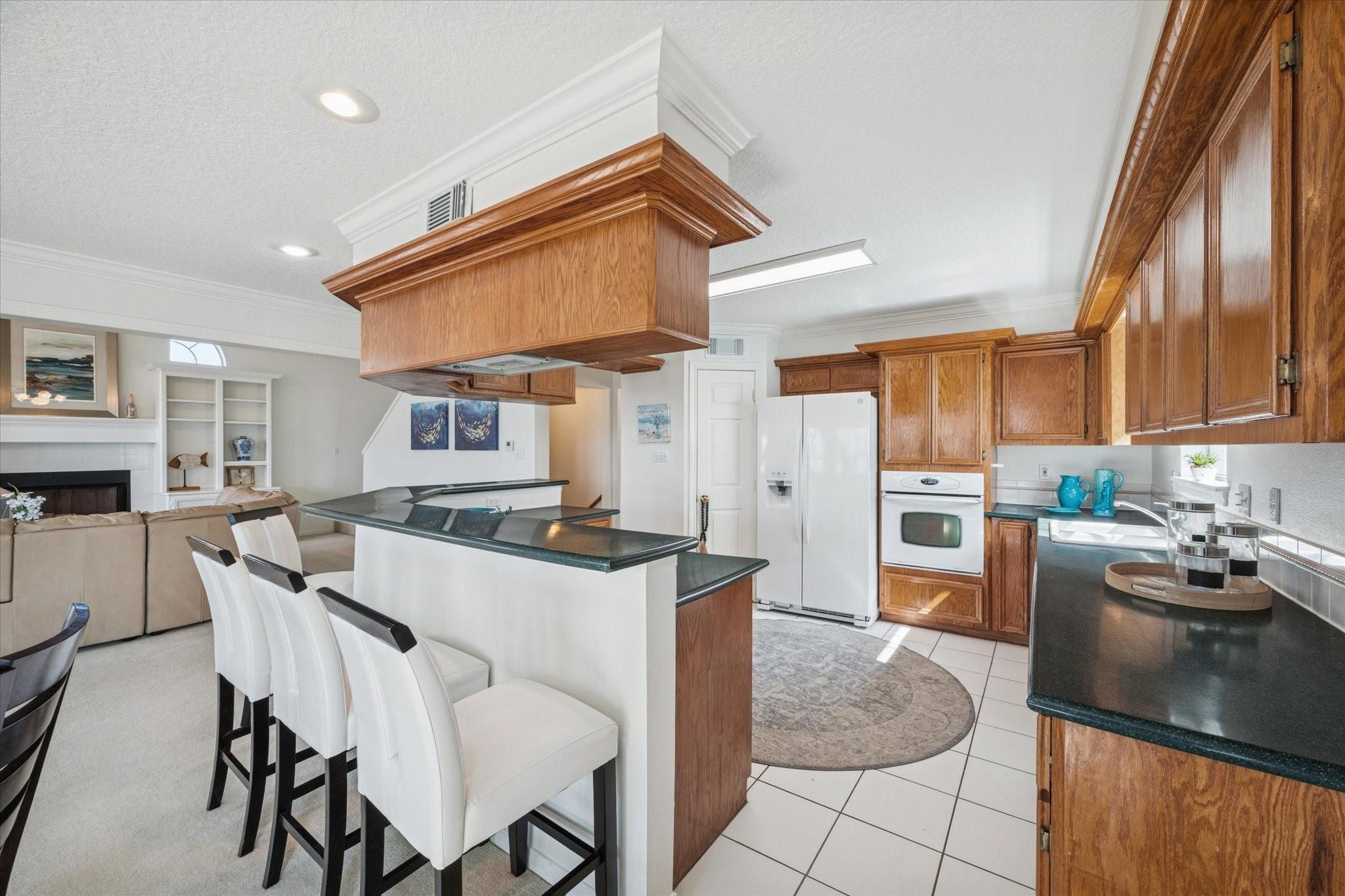 Image 3: This photo showcases a bright, open-concept kitche