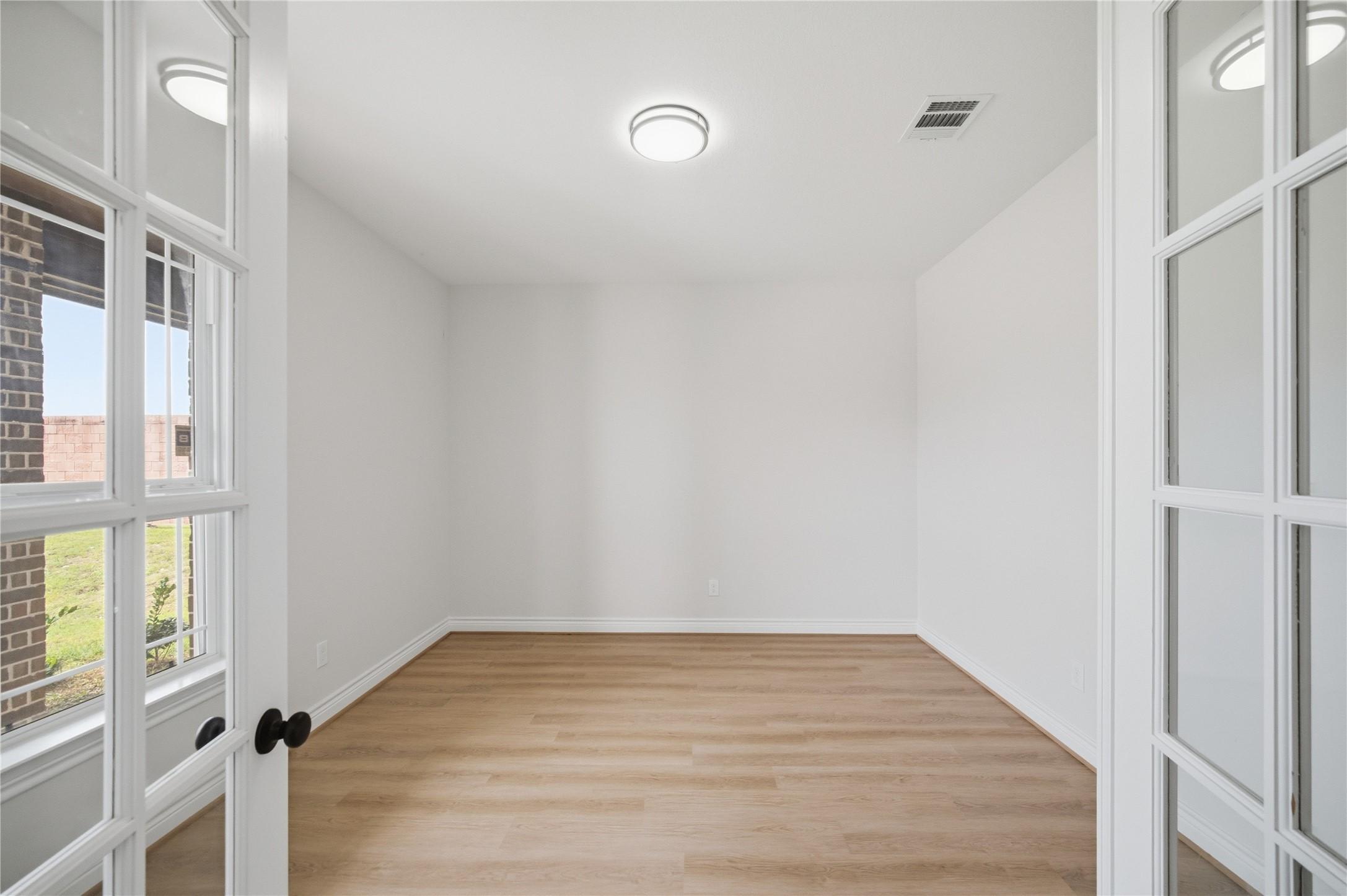 Image 3: The home office sits just off the entry, offering
