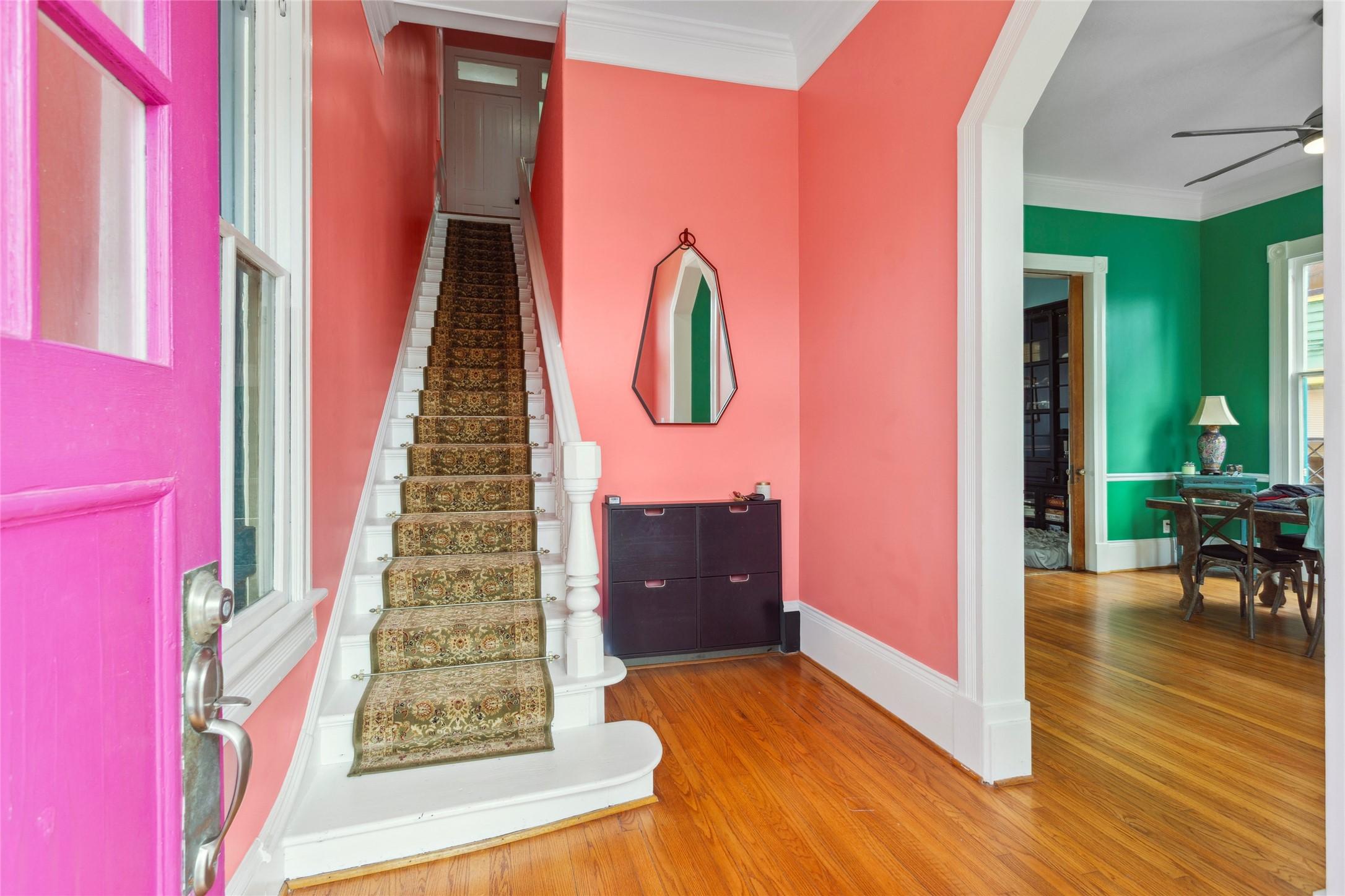 Image 4: This vibrant entryway features a pink front door,
