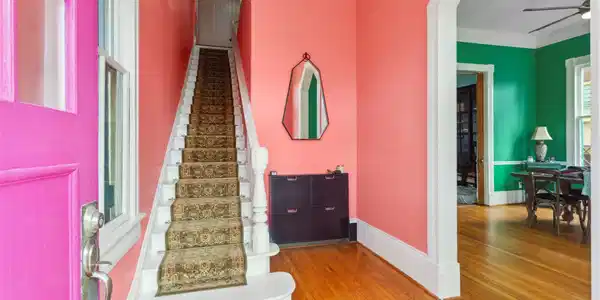 Image 4: This vibrant entryway features a pink front door,