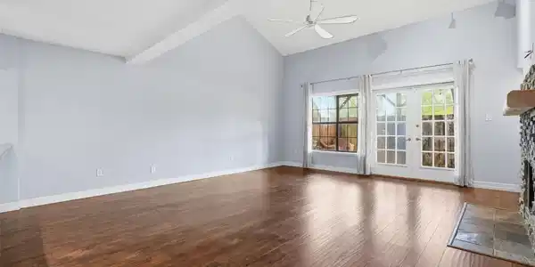 Image 3: Spacious living room featuring soaring ceilings, w