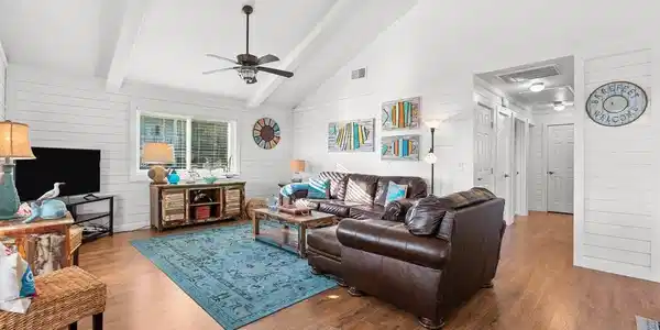 Image 2: This inviting living room features vaulted ceiling