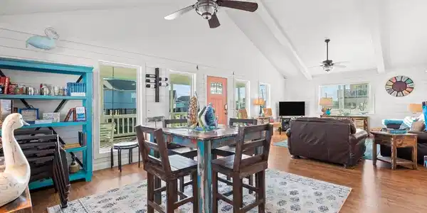 Image 3: This inviting open-concept living space features h