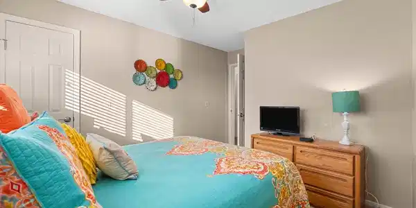Image 4: This cozy bedroom features warm beige walls and a
