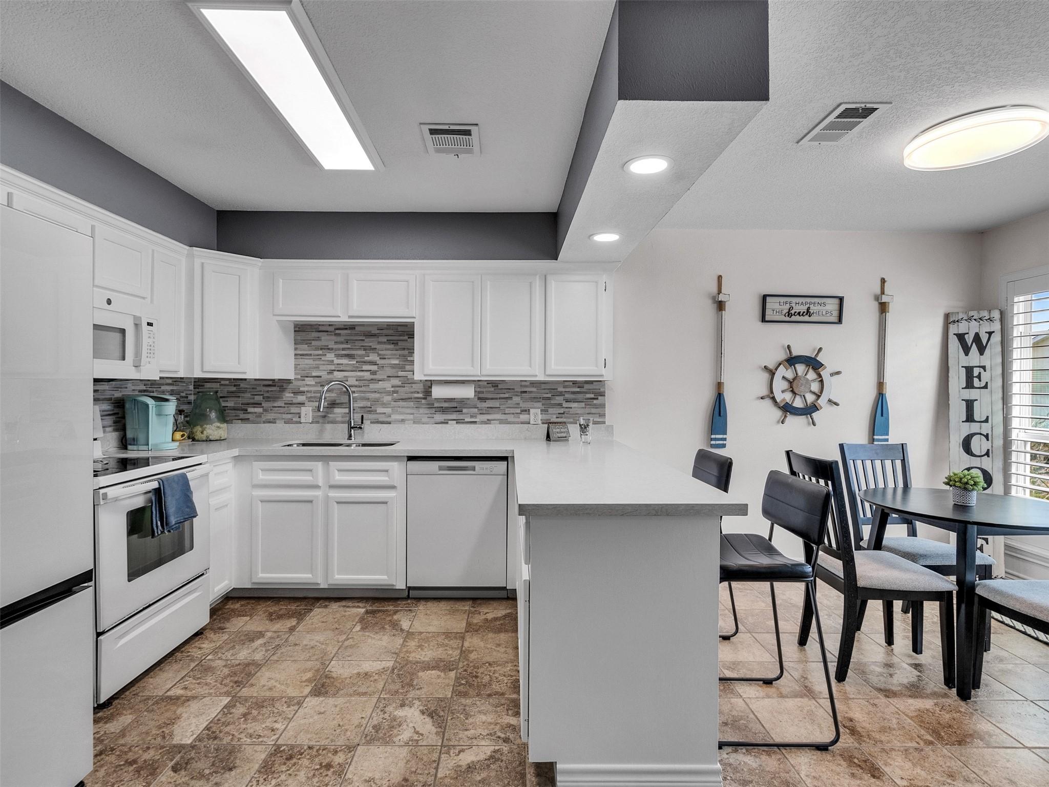 Image 3: Crisp white cabinetry, updated design, and new app