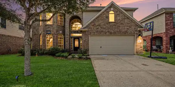Image 2: FRONT ELEVATION AT DUSK.