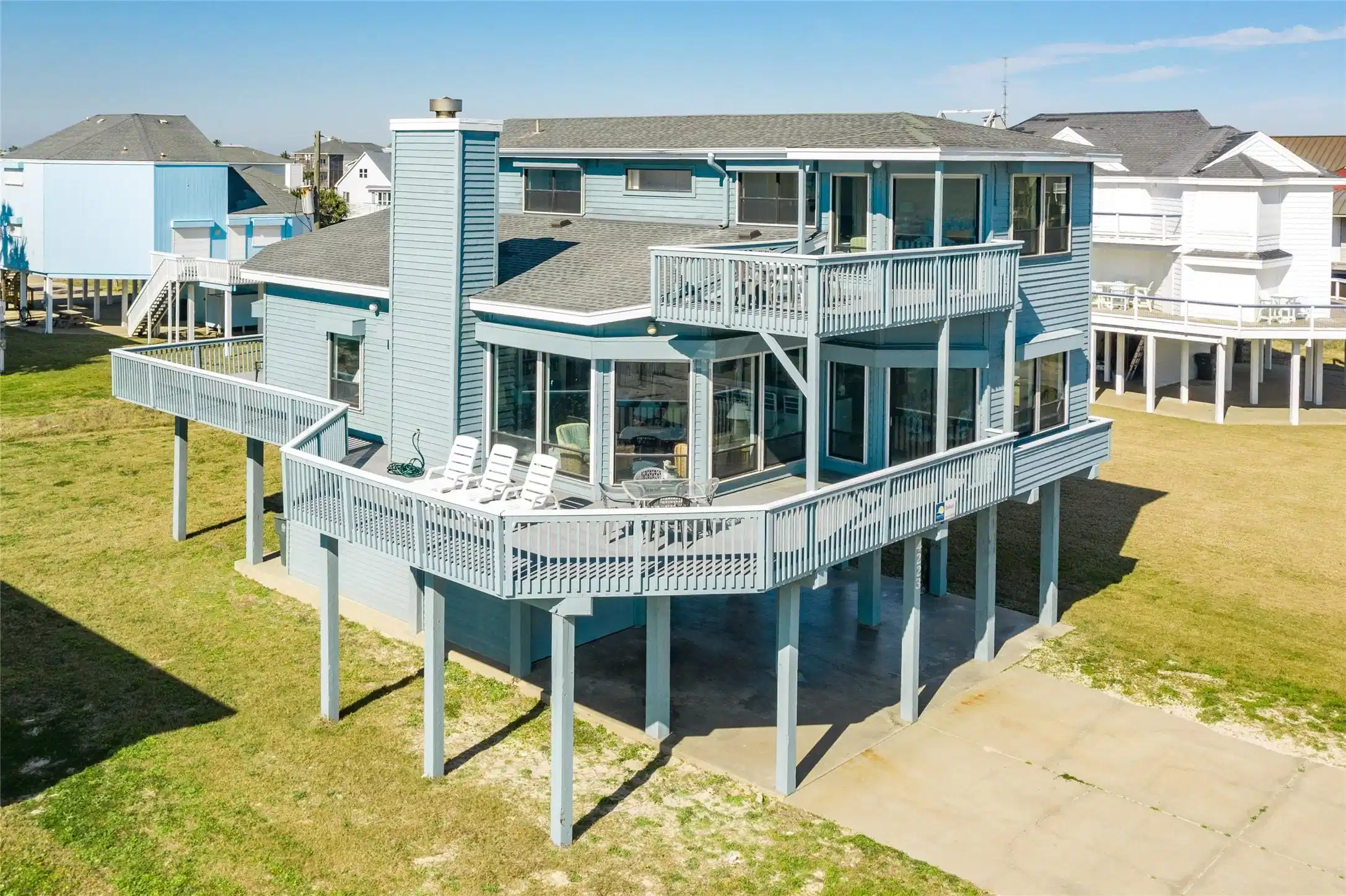 Image 1: Front or home with wall to wall windows for beach