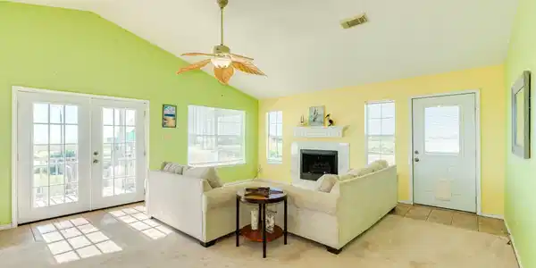 Image 4: Bright open-concept living area with vaulted ceili
